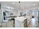 Open concept kitchen and dining area with a large island and modern light fixtures at 2656 Grantham Place Dr, Fort Mill, SC 29715