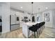Contemporary kitchen featuring white cabinets, stainless steel appliances, and a spacious island with bar stool seating at 2656 Grantham Place Dr, Fort Mill, SC 29715