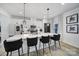 Modern kitchen with white cabinetry, stainless steel appliances, and bar stool seating at the island at 2656 Grantham Place Dr, Fort Mill, SC 29715