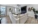Bright living room featuring a large white sectional sofa, modern fireplace, and hardwood floors at 2656 Grantham Place Dr, Fort Mill, SC 29715