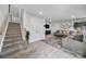 The spacious living room offers a cozy atmosphere with a plush rug, comfortable seating, and staircase access at 2656 Grantham Place Dr, Fort Mill, SC 29715
