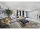 Living room boasting a plush area rug, comfortable gray seating, and natural light from sliding glass doors at 2656 Grantham Place Dr, Fort Mill, SC 29715
