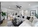 Open-concept living area features stylish decor, hardwood floors, and abundant natural light from several windows at 2656 Grantham Place Dr, Fort Mill, SC 29715