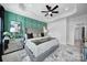 Main bedroom showcasing a tray ceiling, accent wall, and mirrored nightstand with lamps at 2656 Grantham Place Dr, Fort Mill, SC 29715