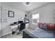 A bright home office features a desk, comfortable seating, and a cozy daybed with decorative pillows at 2656 Grantham Place Dr, Fort Mill, SC 29715