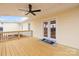 Back deck featuring outdoor ceiling fan, railings, and French door access into the home at 2687 Glenn St, Newton, NC 28658