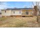 View of the home's back exterior featuring yellow siding and a wood porch and deck at 2687 Glenn St, Newton, NC 28658