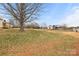 Sprawling backyard with mature trees and view of the home from the rear at 2687 Glenn St, Newton, NC 28658