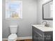 Updated bathroom featuring a single sink vanity with a modern faucet and a window for natural light at 2687 Glenn St, Newton, NC 28658