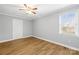 This bedroom has wood floors, a window, ceiling fan, and neutral color paint at 2687 Glenn St, Newton, NC 28658
