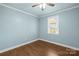 The bedroom boasts natural light with a window offering backyard views, complemented by wood-look flooring at 2687 Glenn St, Newton, NC 28658