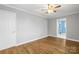 Primary bedroom featuring hardwood floors, ceiling fan, and access to primary bathroom at 2687 Glenn St, Newton, NC 28658