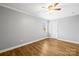 This bedroom is bathed in natural light and is complete with modern wood flooring and a ceiling fan at 2687 Glenn St, Newton, NC 28658