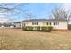 Charming single story home with yellow siding, black shutters and a matching covered carport at 2687 Glenn St, Newton, NC 28658