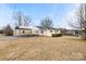 The exterior shows covered parking and a storage shed with a beautiful front lawn at 2687 Glenn St, Newton, NC 28658