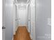 A well-lit hallway with wood-look floors connects various rooms, featuring neutral wall paint at 2687 Glenn St, Newton, NC 28658