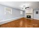 Empty living room boasts hardwood floors, fireplace, neutral walls, and ample natural light at 2687 Glenn St, Newton, NC 28658