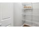 This walk-in closet features ample storage space with white shelving and wood-look flooring at 2687 Glenn St, Newton, NC 28658