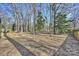 Large backyard with mature trees offering shade and privacy at 2827 Temple Ln, Charlotte, NC 28205