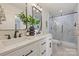 Modern bathroom featuring a double vanity, stylish mirrors, and a glass-enclosed shower at 2827 Temple Ln, Charlotte, NC 28205
