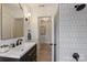 Bright bathroom with a modern vanity, black hardware, and a subway-tiled shower at 2827 Temple Ln, Charlotte, NC 28205