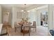 Cozy dining area with a round table, modern light fixture, and seamless access to the kitchen and outdoor patio at 2827 Temple Ln, Charlotte, NC 28205