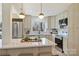 Bright kitchen featuring stainless steel appliances, white countertops, and contemporary pendant lighting at 2827 Temple Ln, Charlotte, NC 28205