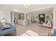 Bright and airy living room flows to kitchen with island, fireplace and seating for entertaining and relaxation at 2827 Temple Ln, Charlotte, NC 28205