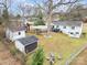 Spacious backyard with multiple sheds, car port, patio and fire pit at 3231 Eastwood Dr, Charlotte, NC 28205