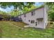 The rear exterior of the home has a combination of brick and siding, along with a deck and carport at 3231 Eastwood Dr, Charlotte, NC 28205