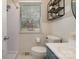 Cozy bathroom with a shower, toilet and sink below a bright window at 3231 Eastwood Dr, Charlotte, NC 28205