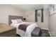Neutral bedroom featuring a full bed, wood floors, and a window at 3231 Eastwood Dr, Charlotte, NC 28205