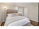 Cozy bedroom features a plush bed, side table, and warm natural light at 3231 Eastwood Dr, Charlotte, NC 28205