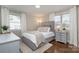 Comfortable bedroom with lots of natural light from the windows, and hardwood floors at 3231 Eastwood Dr, Charlotte, NC 28205