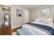 Comfortable bedroom with wood floors and a sitting bench at the foot of the bed at 3231 Eastwood Dr, Charlotte, NC 28205