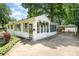Charming home with a covered carport and a cozy sunroom, complemented by lush landscaping and curb appeal at 3231 Eastwood Dr, Charlotte, NC 28205