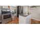Kitchen featuring stainless steel oven and fridge, movable island and an open view of the living room at 3231 Eastwood Dr, Charlotte, NC 28205