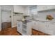 Bright kitchen featuring white cabinets, stainless steel appliances, and a movable island at 3231 Eastwood Dr, Charlotte, NC 28205