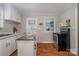 View of a bright kitchen featuring white cabinets, movable island and stainless steel oven at 3231 Eastwood Dr, Charlotte, NC 28205