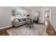 Inviting living room with a stylish rug, comfortable seating, and large windows providing natural light at 3231 Eastwood Dr, Charlotte, NC 28205