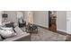 View of a cozy living room featuring hardwood floors, gray sofa and a view into the kitchen at 3231 Eastwood Dr, Charlotte, NC 28205