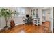 Bright office with hardwood floors, a large desk, and an acoustic guitar at 3231 Eastwood Dr, Charlotte, NC 28205
