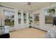 Bright sunroom with large windows, white curtains, a ceiling fan, and a cozy rug and decor at 3231 Eastwood Dr, Charlotte, NC 28205