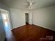 A bedroom with hardwood floors, a ceiling fan, and a closet at 326 Anderson Grove Church Rd, Albemarle, NC 28001