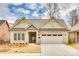 Charming brick home with a two-car garage, manicured lawn, and classic architectural details at 333 Lifestyle Ct, Cramerton, NC 28056
