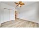 Bright bedroom with light wood floors, white walls, and a leaf-motif ceiling fan at 333 Lifestyle Ct, Cramerton, NC 28056
