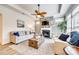 Comfortable living room features a stone fireplace, wooden fan, and stylish furniture at 333 Lifestyle Ct, Cramerton, NC 28056