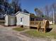 The home's backyard features a wooden deck, siding, and a door for access at 3410 Nc 109 N Hwy, Wadesboro, NC 28170