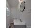 This bathroom features a sink, toilet, mirror, window, and modern lighting at 3410 Nc 109 N Hwy, Wadesboro, NC 28170