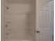 Bathroom showcasing a tub and shower with white tiled surround, fixture and door at 3410 Nc 109 N Hwy, Wadesboro, NC 28170
